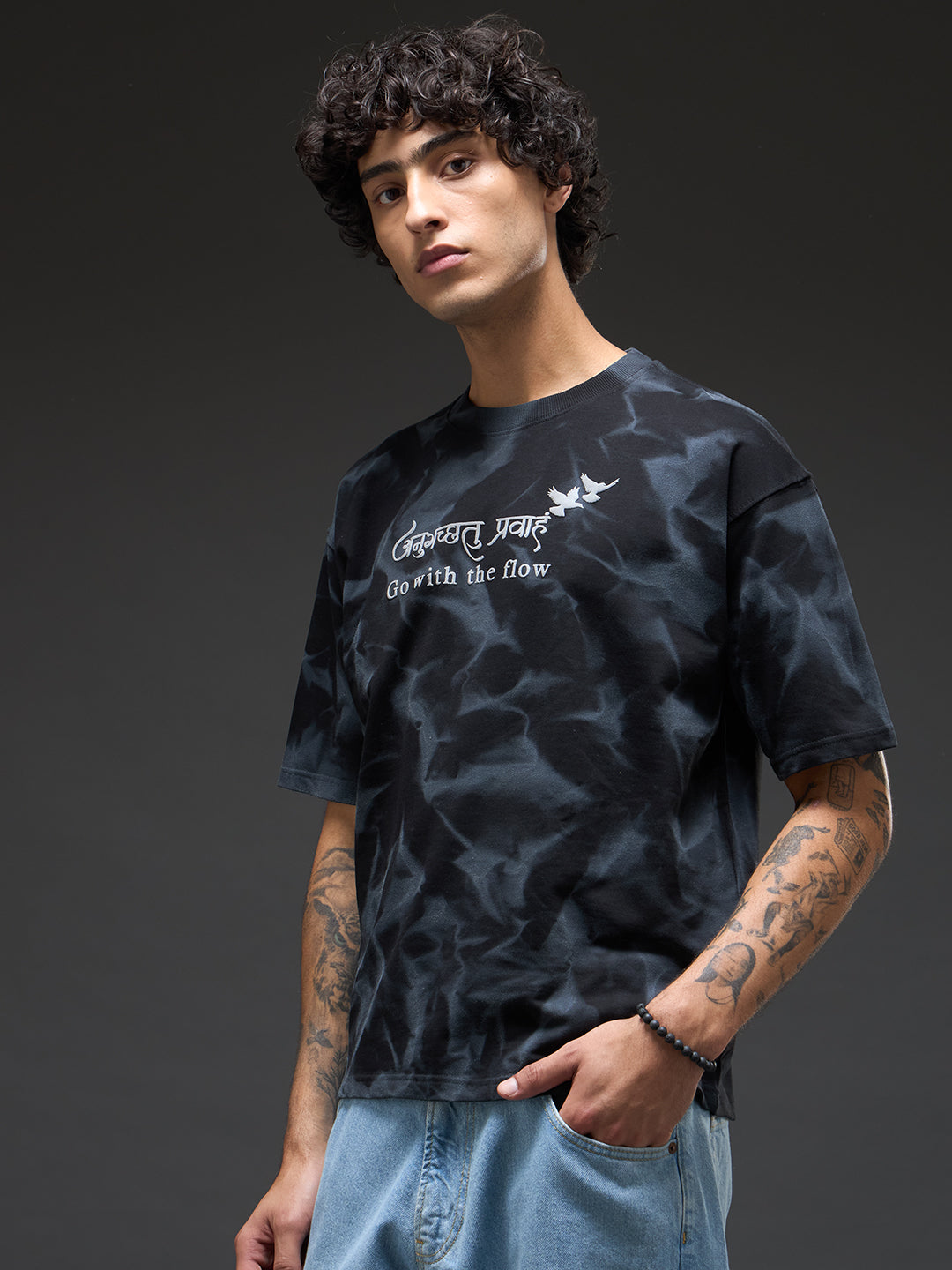 Black oversized T-shirt with spray and puff print from Rudrajap's Go with the Flow collection, shown on a plain background.