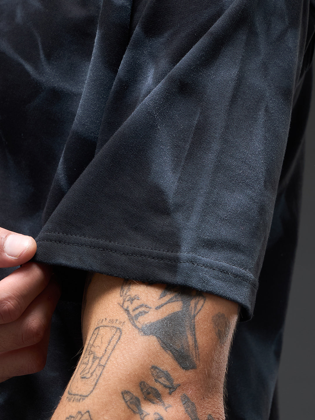 Black oversized T-shirt with spray and puff print design by Rudrajap, featuring a relaxed fit and stylish graphic details.