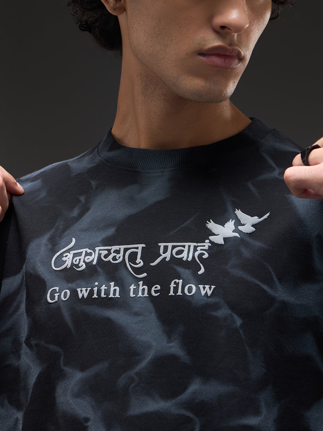 Black oversized T-shirt with spray and puff print design by Rudrajap, featuring a relaxed fit and casual style.