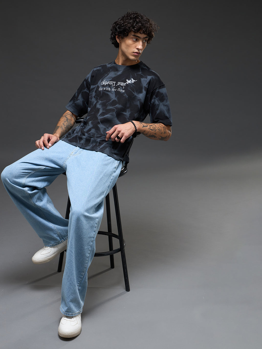 Black oversized tee by Rudrajap with spray and puff print, featuring a relaxed fit and casual streetwear style.