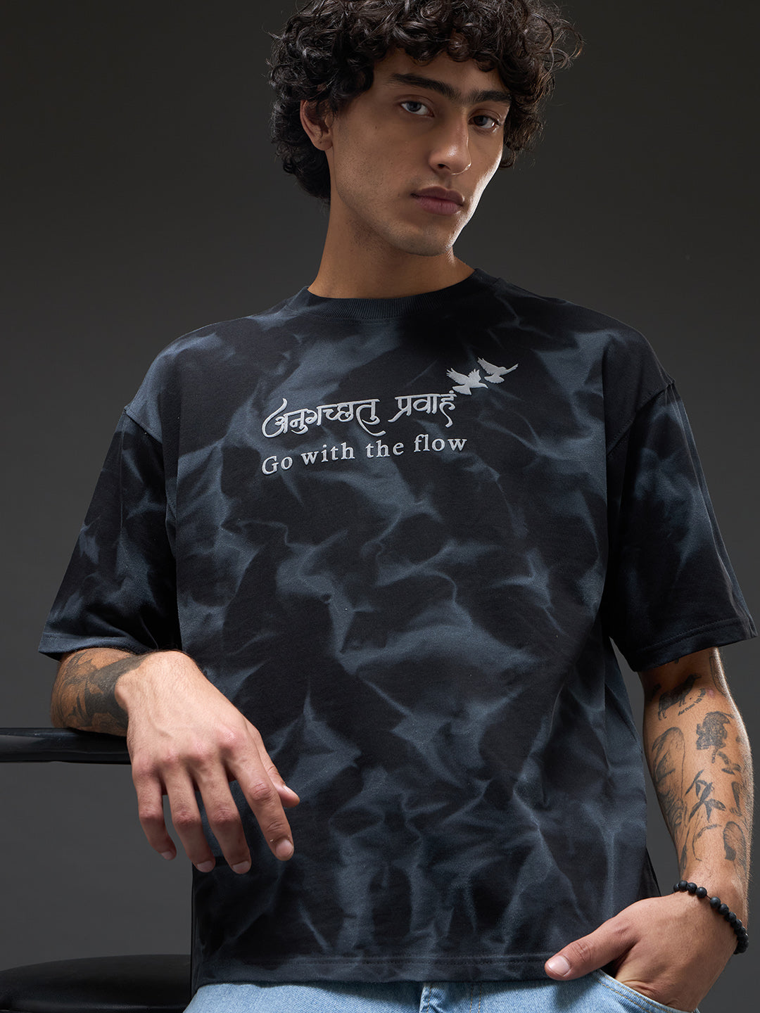 Black oversized T-shirt with spray and puff print by Rudrajap, featuring a relaxed fit and graphic design.