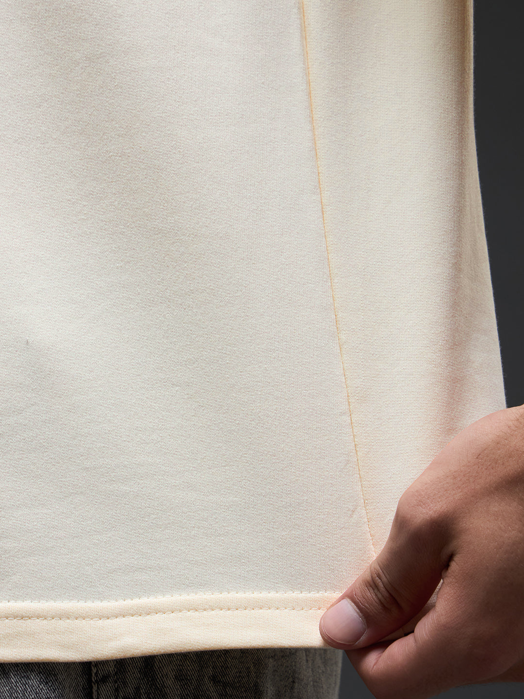 Rudrajap Tatva oversized T-shirt in neutral color, featuring a relaxed fit and casual style, displayed on a hanger.