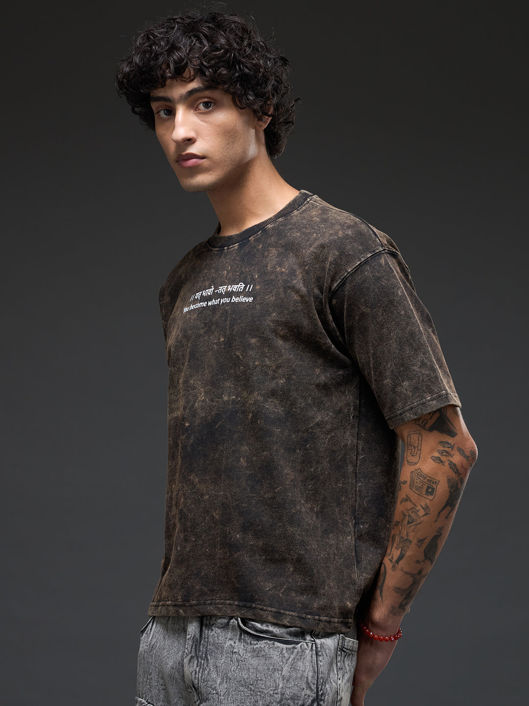 Black acid wash oversized T-shirt by Rudrajap featuring Sanskrit quote "।। यत् भावो – तत् भवति ।।" with bold lettering.