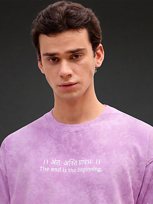 Lavender acid wash oversized T-shirt by Rudrajap with Sanskrit quote "Antah Asti Prarambhah" printed in black text.