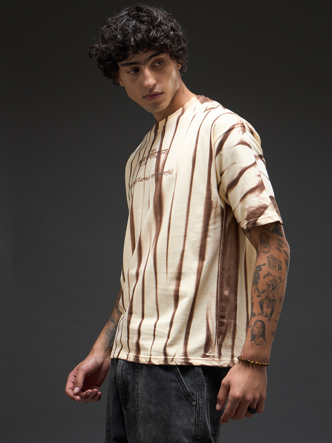 Beige oversized T-shirt with spray and puff print from Rudrajap's Law of Karma collection, featuring relaxed fit and casual style.