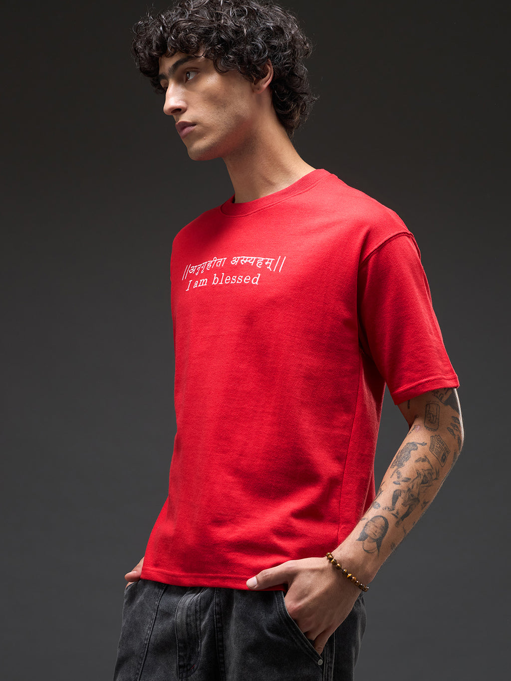 Red recycled oversized tee from Rudrajap with "I Am Blessed" embroidery, showing its relaxed fit and premium stitched details.