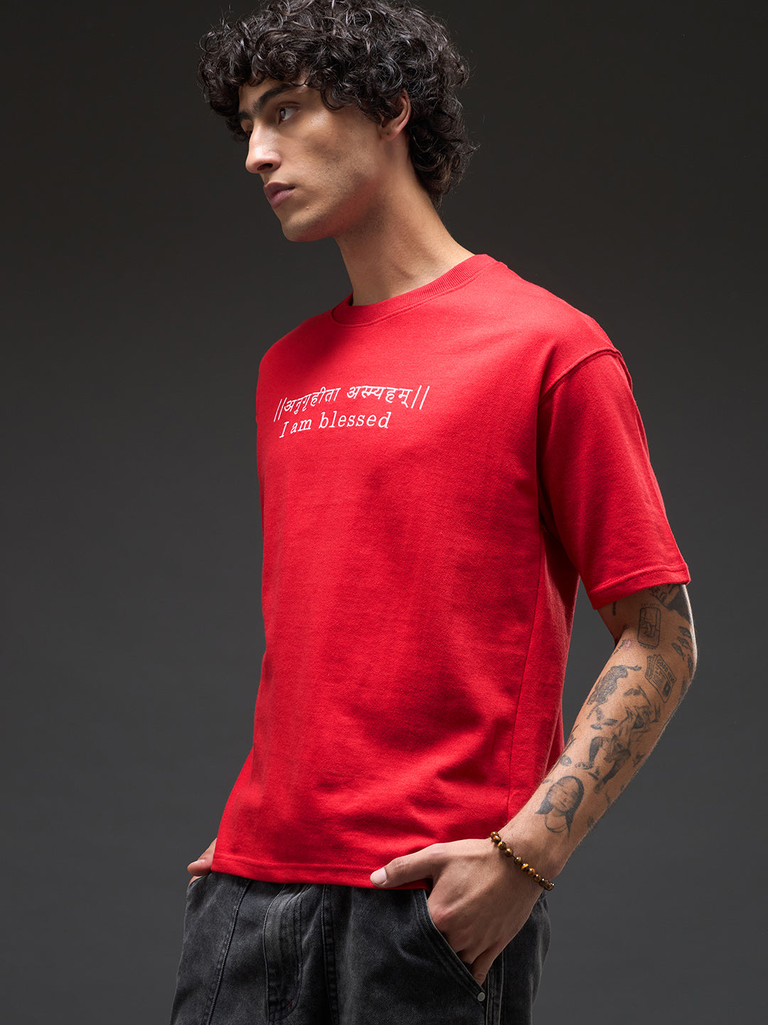 Red recycled oversized tee from Rudrajap with "I Am Blessed" embroidery, showing its relaxed fit and premium stitched details.