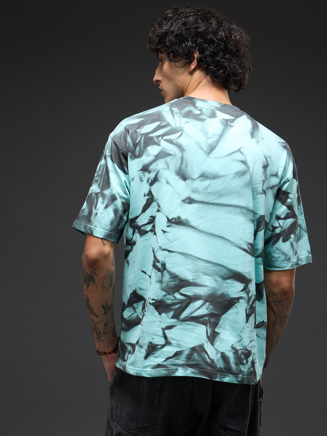 Mint green oversized tee with spray and puff print details by Rudrajap, casual fit, displayed on a hanger with a plain background.