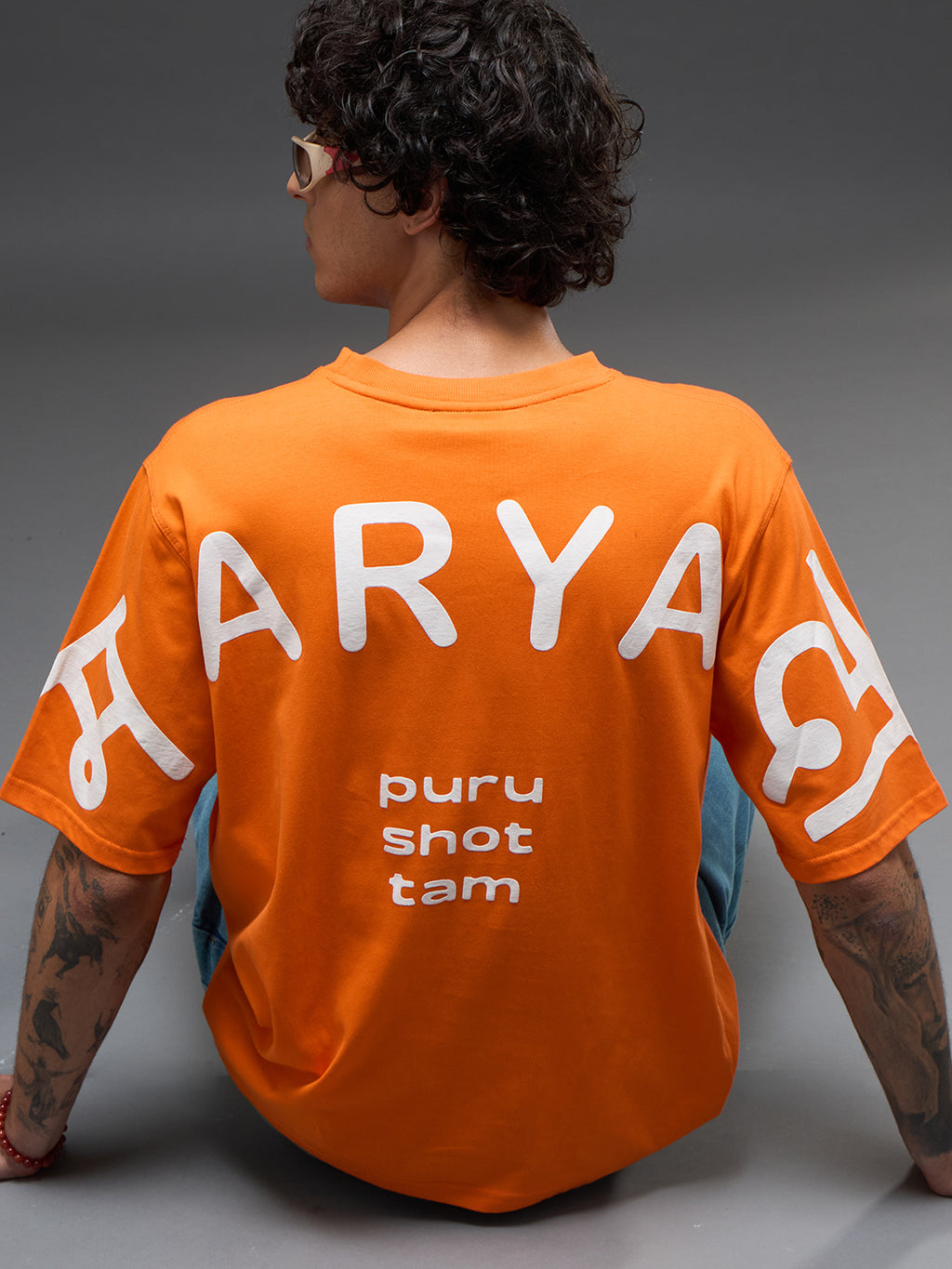 Rudrajap Purushottam oversized T-shirt in a relaxed fit, displayed on a hanger with a casual, stylish design.
