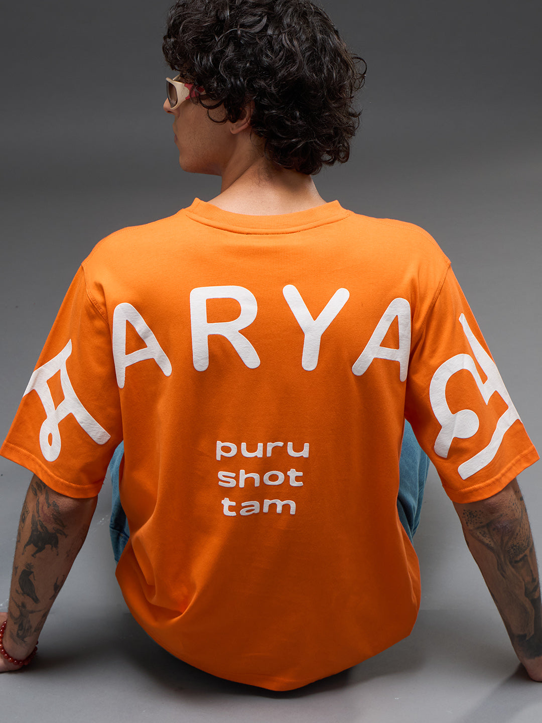 Rudrajap Purushottam oversized T-shirt in a relaxed fit, displayed on a hanger with a casual, stylish design.