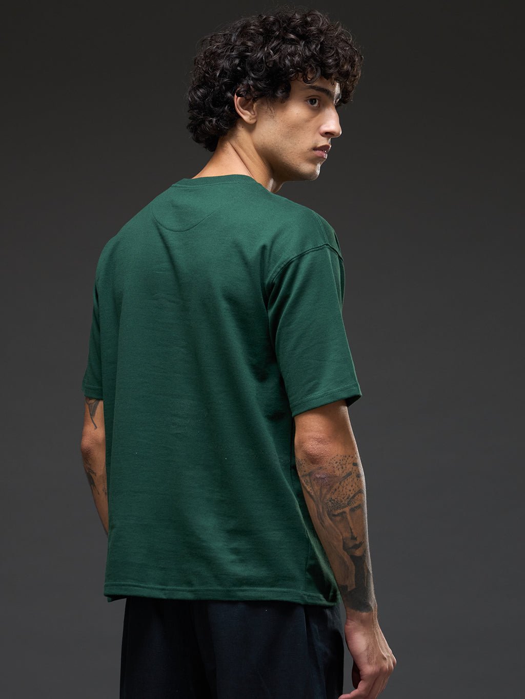 Bottle green recycled oversized tee with "Go With The Flow" embroidery from Rudrajap, showing front view of relaxed fit and embroidered detail.