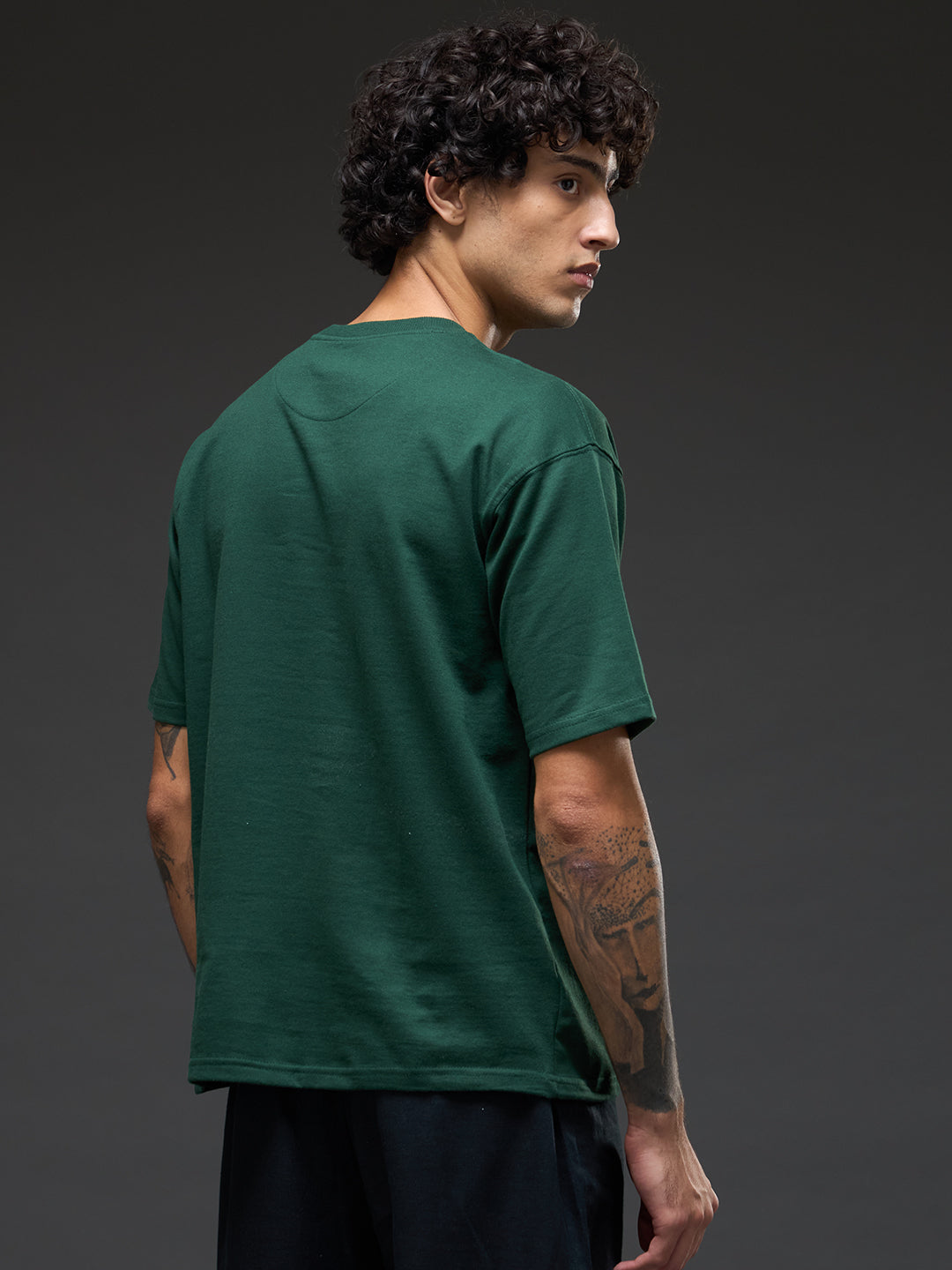 Bottle green recycled oversized tee with "Go With The Flow" embroidery from Rudrajap, showing front view of relaxed fit and embroidered detail.