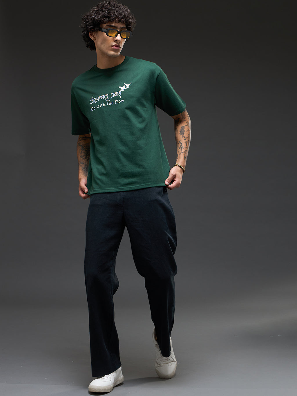 Bottle green recycled oversized T-shirt by Rudrajap with "Go With The Flow" embroidery, shown laid flat on a white background.