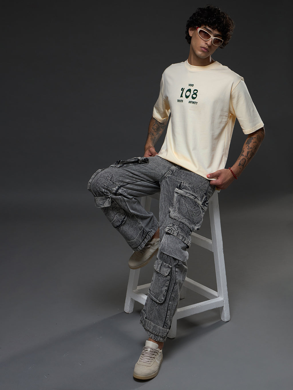 Rudrajap Tatva oversized T-shirt in neutral color, featuring a relaxed fit and casual style, displayed on a hanger.