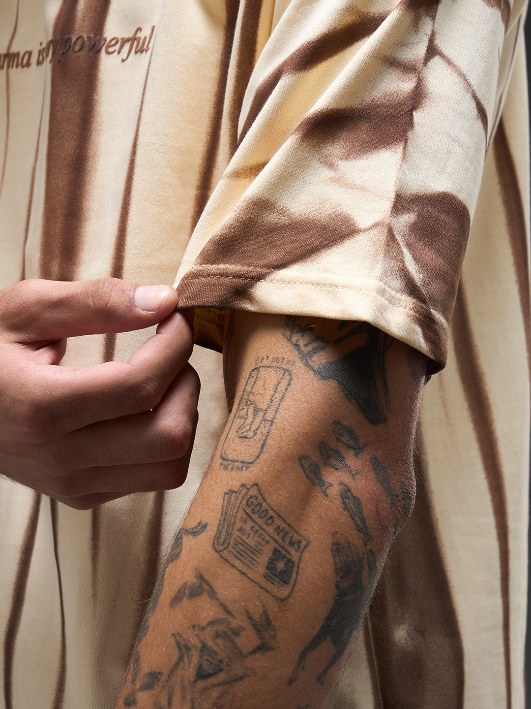 Beige oversized tee with spray and puff print design by Rudrajap, featuring a relaxed fit and casual style.