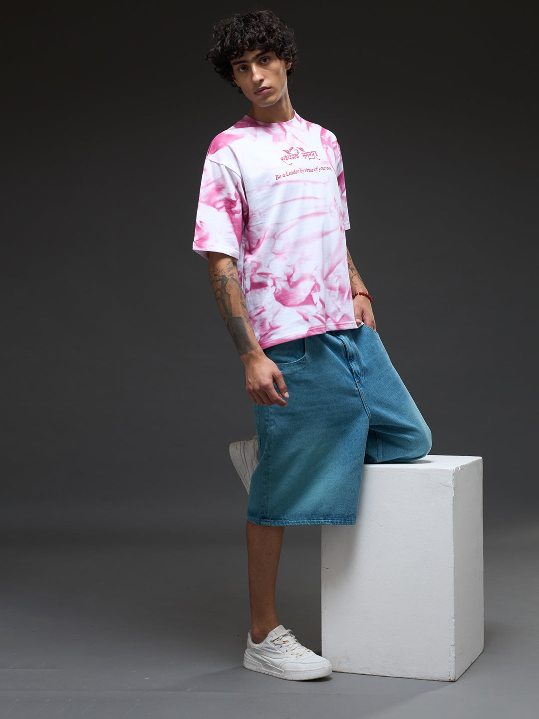 White oversized tee from Rudrajap with spray and puff print design, featuring a relaxed fit and casual style.