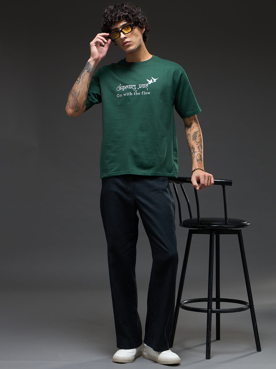 Bottle green recycled oversized tee by Rudrajap with "Go With The Flow" embroidery, shown on a plain background.