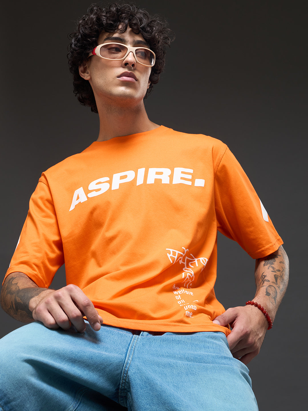 Rudrajap Purushottam oversized T-shirt in neutral color, casual fit, displayed on hanger with front view.