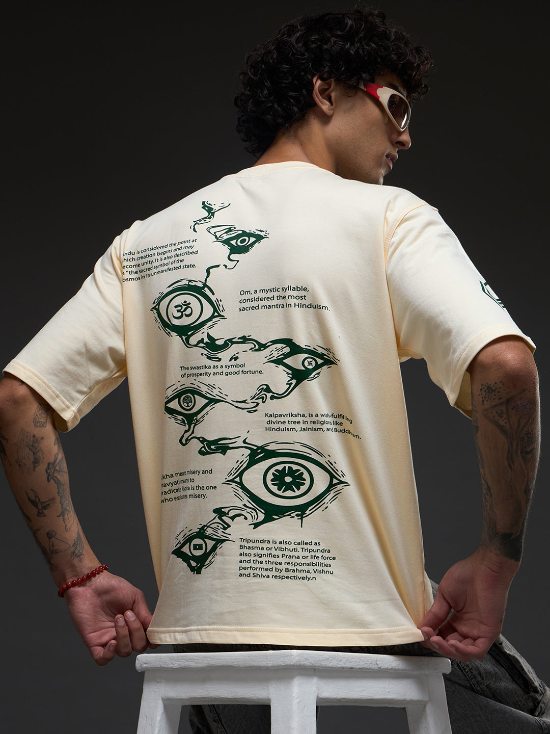 Rudrajap Tatva oversized T-shirt in neutral fabric, displayed flat with a relaxed fit and simple design.