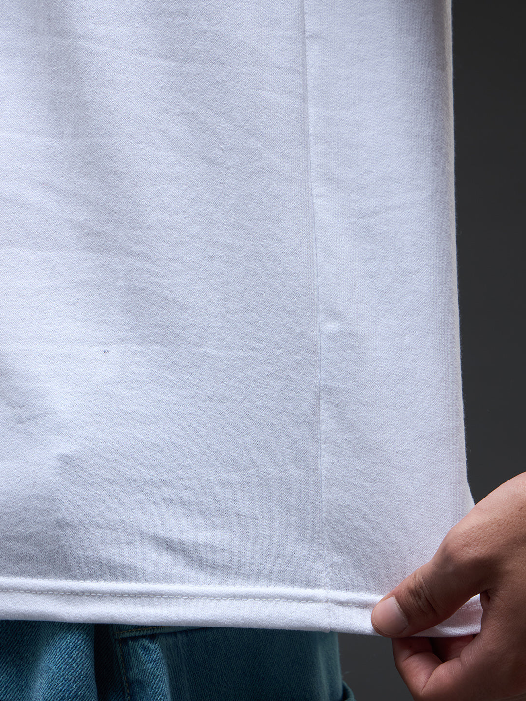 White and beige recycled oversized tee by Rudrajap featuring a relaxed fit and casual style, displayed on a hanger.